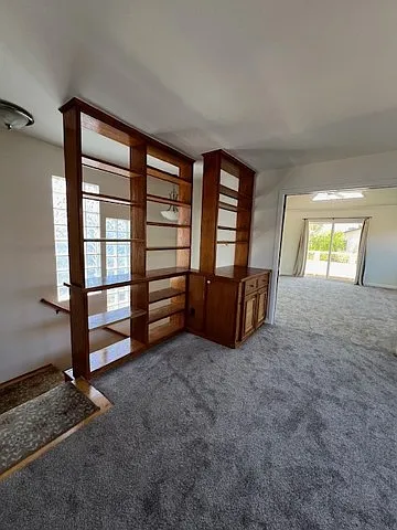 Upstairs landing with custom shelving and open area/bonus room