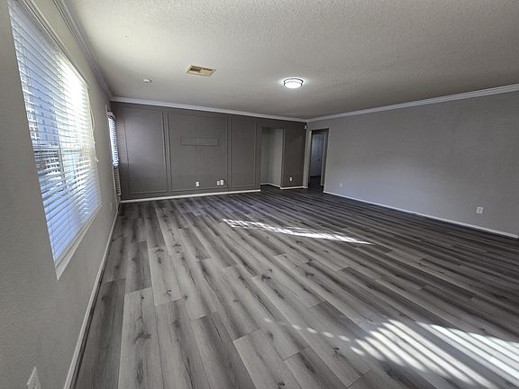 Living Room with Brand New Floors and accent wall.