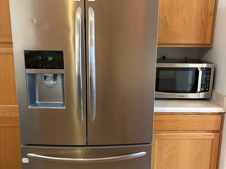 Kitchen with refrigerator and microwave