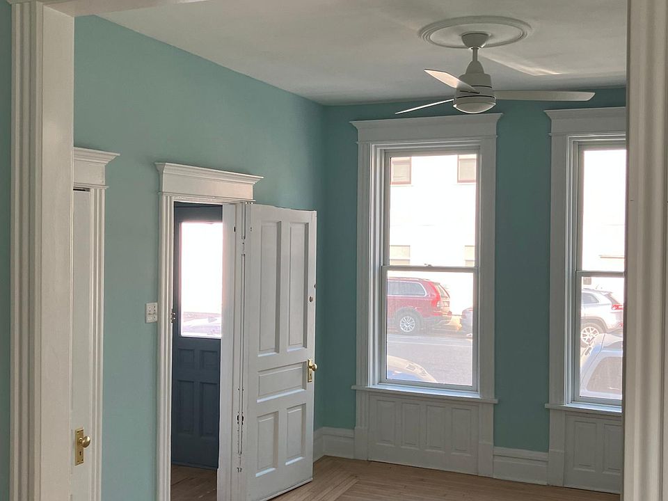 living room with fan, closet and entryway