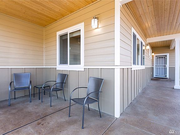 Covered patio with main entry on right, on the SE corner of the home.  