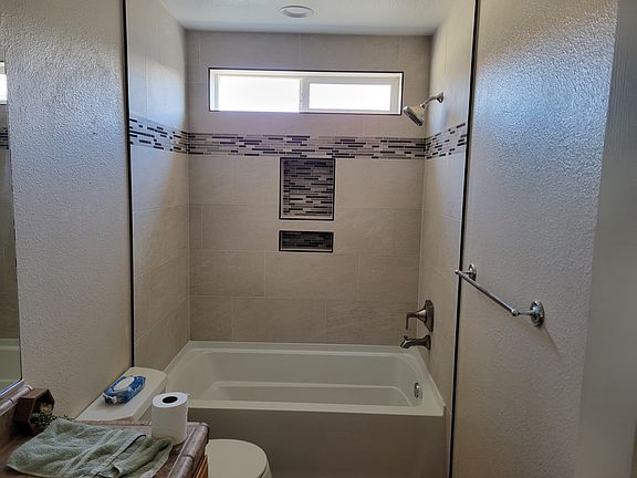 Remolded bath with new bath fixtures and canned lighting.