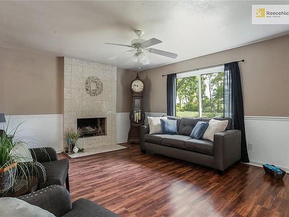 Living Room with cozy fireplace. Newer Maintenance free vinyl windows throughout.