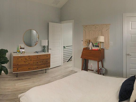 Secondary bedroom upstairs with vaulted ceiling