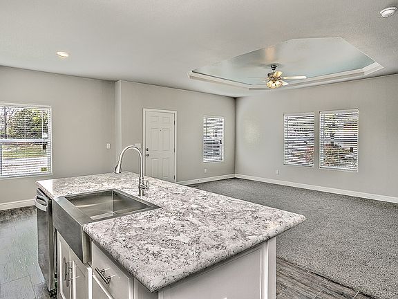 Open & spacious "great room", living room, kitchen, & dining area.  Vaulted ceilings (no coffers), transom windows, upgraded trim, flooring, ceiling fans, & 2" faux wood blinds.