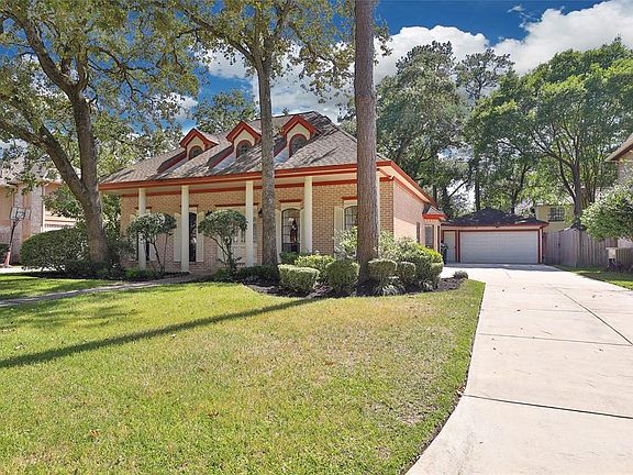 Long driveway leading to detached garage offers plenty of room for parking.