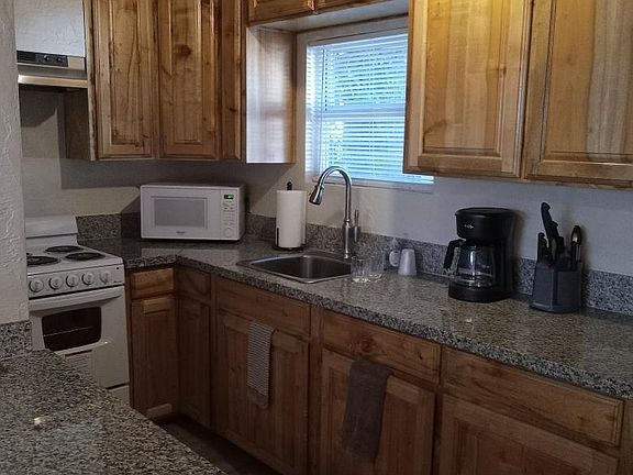 The Kitchen is a Galley Style 
Standard Refrigerator-Freezer,
Electric Stove, Microwave, Coffeemaker, Toaster, and is stocked with cooking and serving
items.