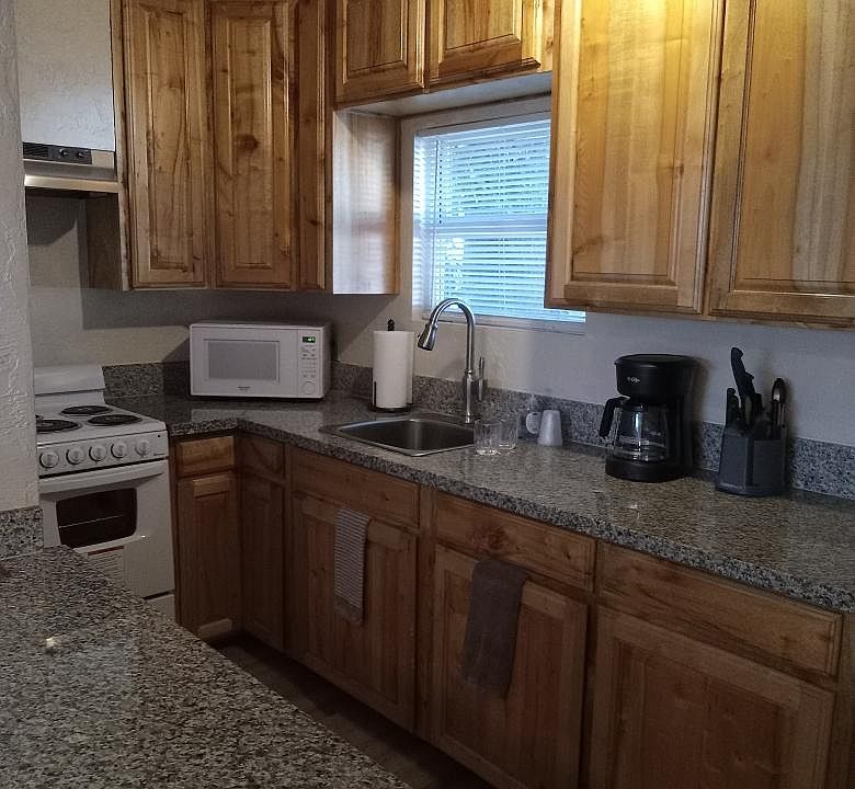 The Kitchen is a Galley Style 
Standard Refrigerator-Freezer,
Electric Stove, Microwave, Coffeemaker, Toaster, and is stocked with cooking and serving
items.