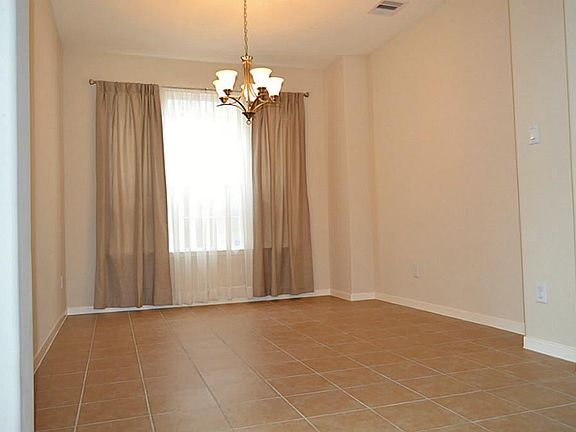 Spacious dining room with curtains included