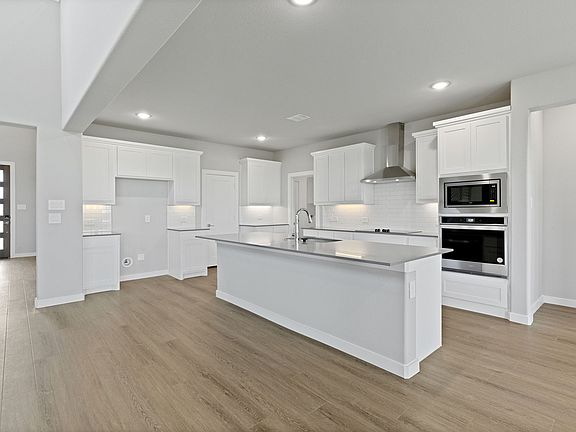 Kitchen in the Henley home plan by Trophy Signature Homes - REPRESENTATIVE PHOTO