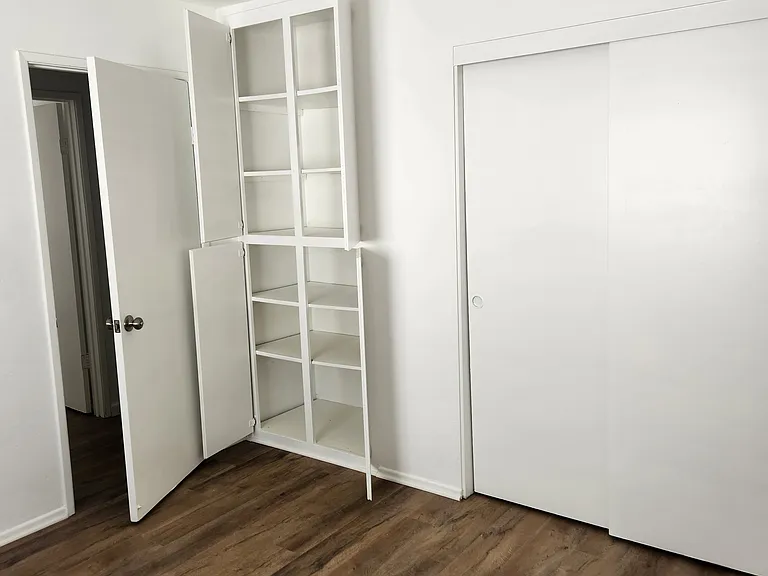Bedroom #2 also has cabinets with shelves.