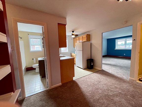 Spacial view of (left to right) bathroom, kitchen area, breakfast nook, and living room / front windows