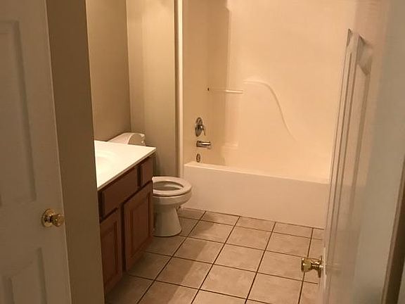 large bathroom, adjacent to the hall laundry room