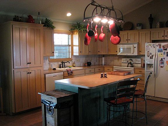Open kitchen with large island/breakfast bar that opens to living area