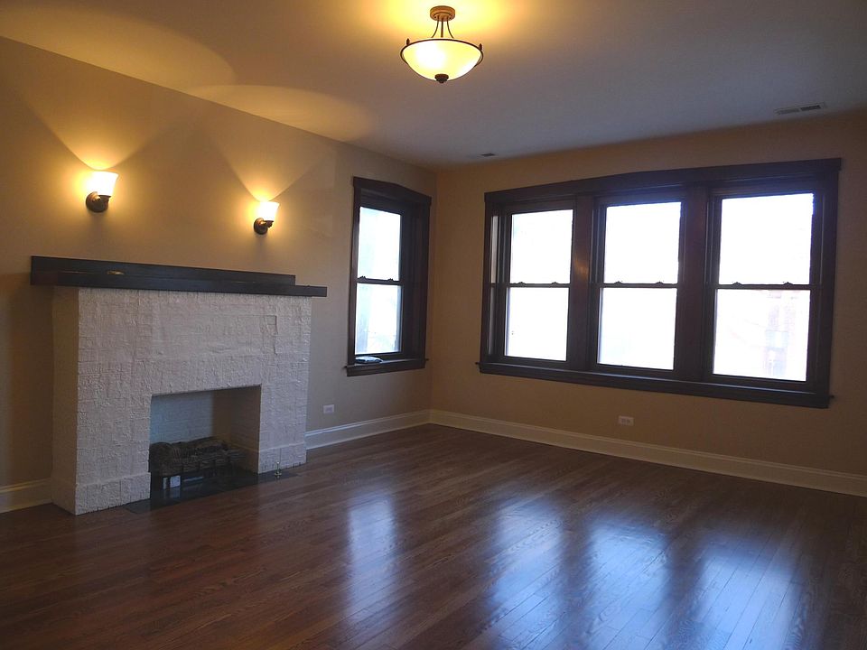 Living room with decorative fireplace; beautiful oak floors