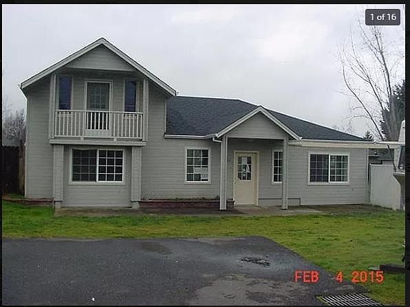 Front of house. There is now a climbing rose on the arbor.