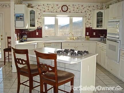 Kitchen is bright with wonderful views : Great for entertaining, has lots of cabinet space & a gas c
