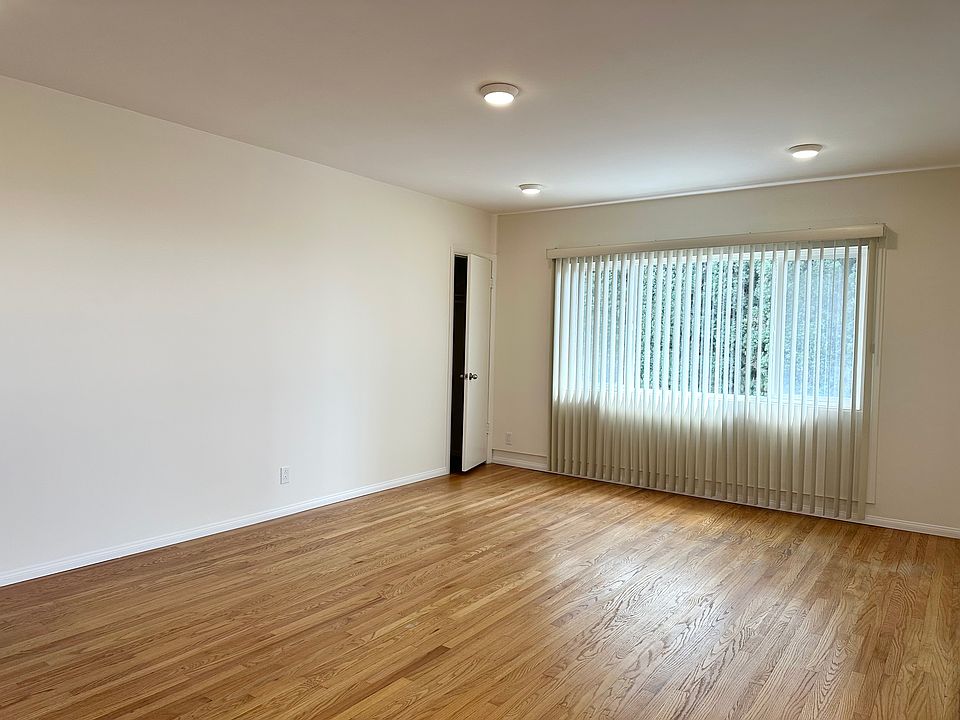 Livingroom with hardwood floors, large window, and coat closet