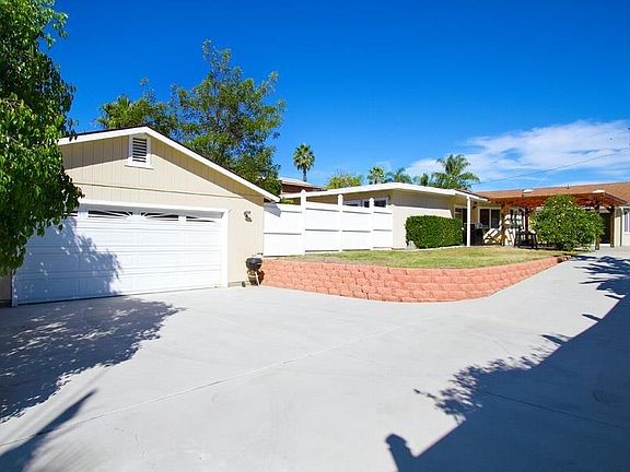 Gated yard with long drive way.