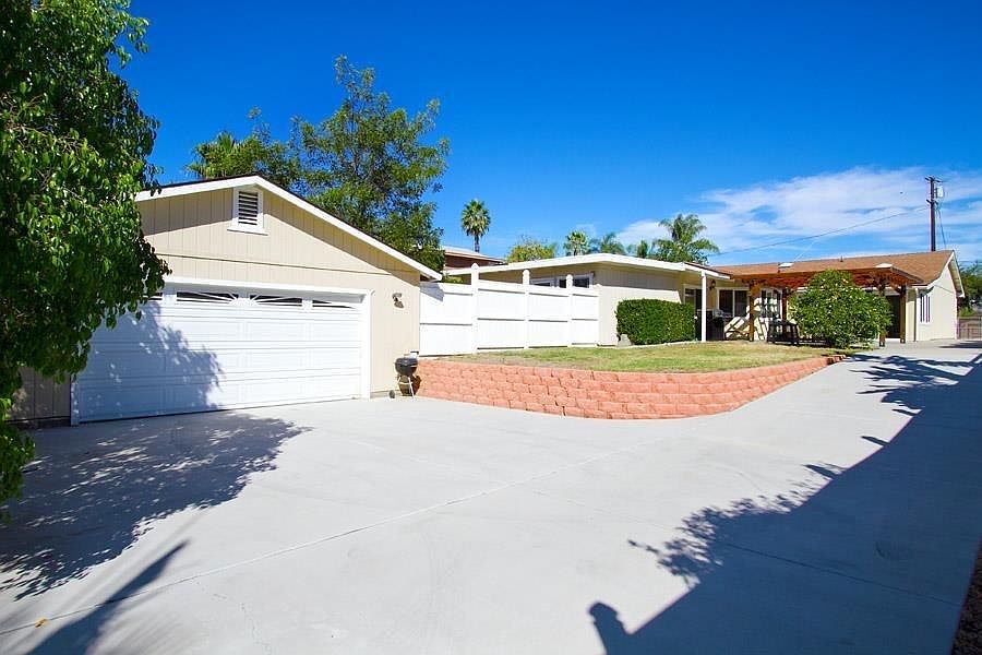 Gated yard with long drive way.
