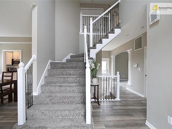 Gorgeous entryway! All new flooring and neutral grays through home. All the baseboards are new as well!