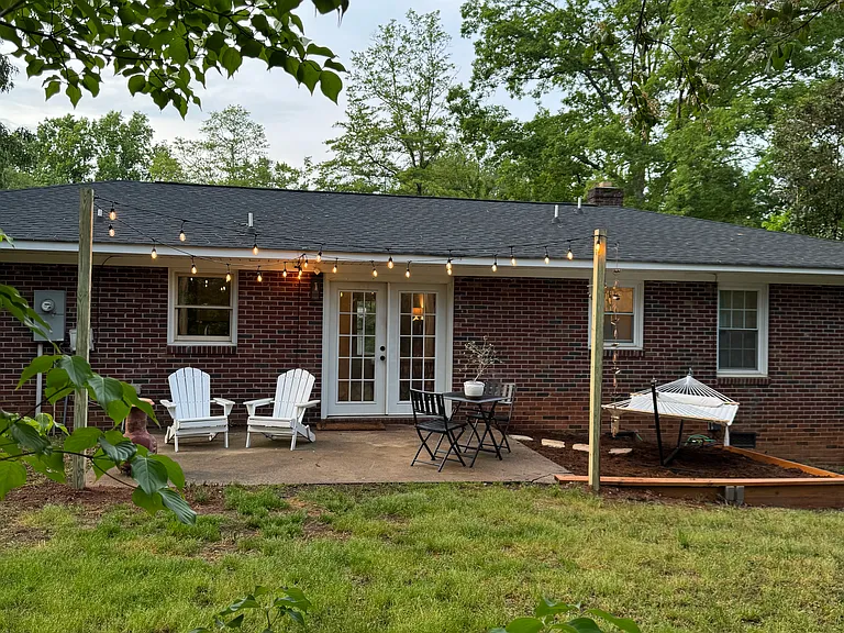 Backyard - mix of shade and sun, mature grassy lawn. Lawn service included in rent.