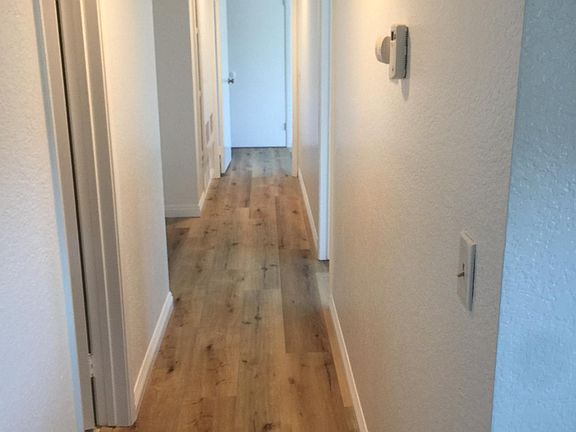 beautiful current wood laminate flooring and white paint