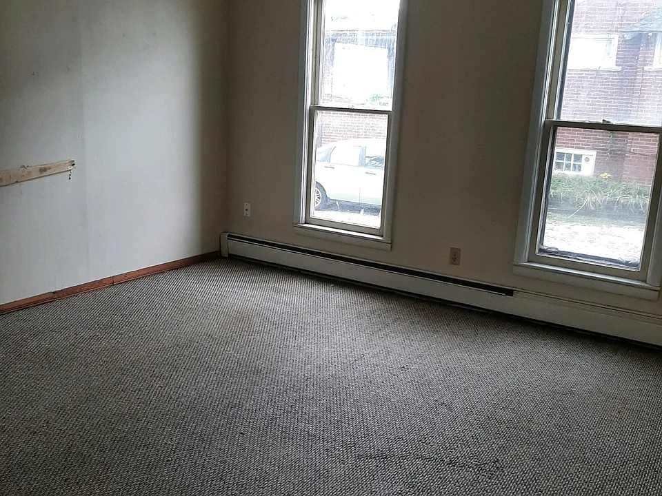 Bedroom with natural light (carpet replaced with new flooring)