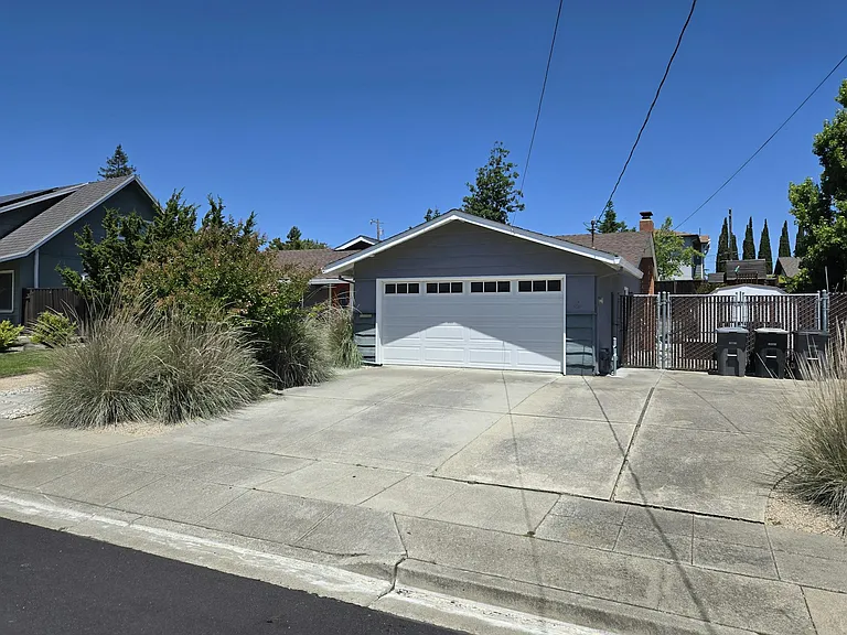2 Car garage and 3 Car Driveway with triple opening fence through to side yard