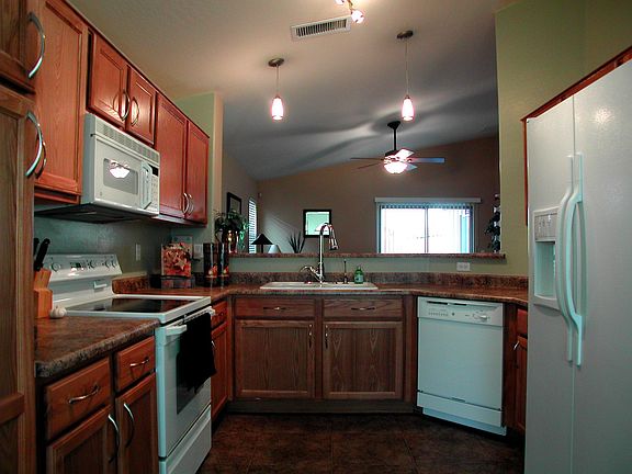 Kitchen with upgraded appliances, lighting, and cabinet hardware