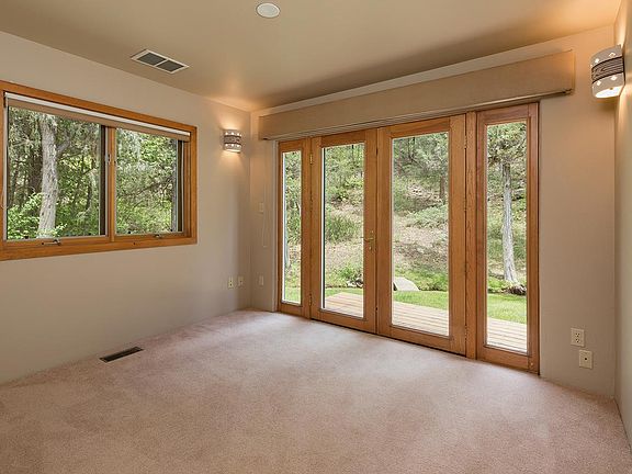 Office/TV room with patio facing the creek.