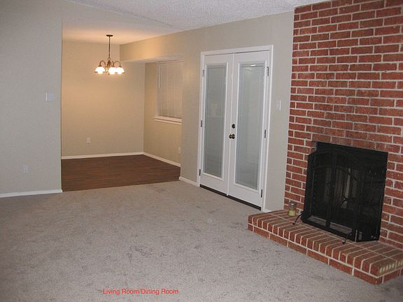 Fireplace, Dining Room and French Doors to Backyard view across living room