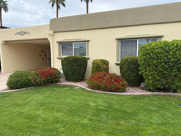 Mature grassy front yard maintained by landlord