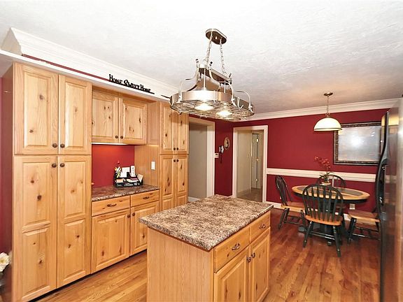 Kitchen has wood floors, plenty of cabinet and counter space.