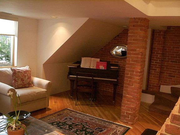 Lower-level has a cozy living room with a niche for a small