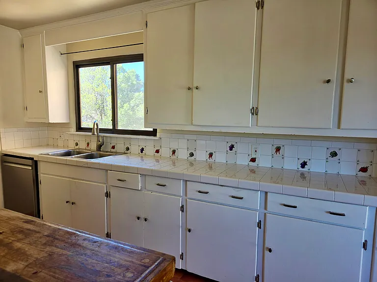 Kitchen with new appliances and many cabinets