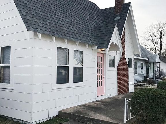 Concrete front porch with security landscaping.
