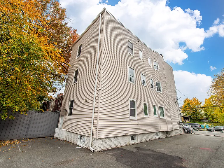 back of house with parking