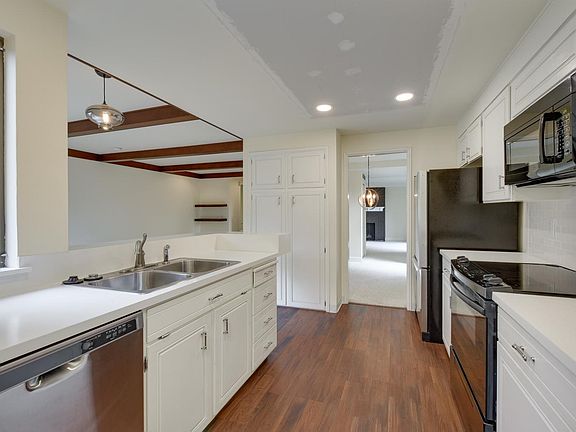 Kitchen with built-in pantry and newer appliances