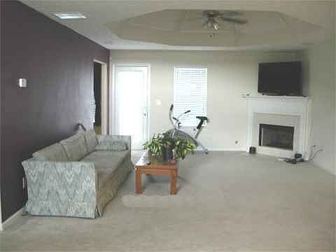 Spacious family room with fancy trey ceiling and wall-to-wall carpeting, open 