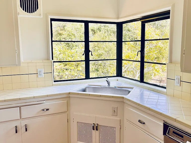 Splendid over sink view, with hinge pop out windows in the retro style kitchen.