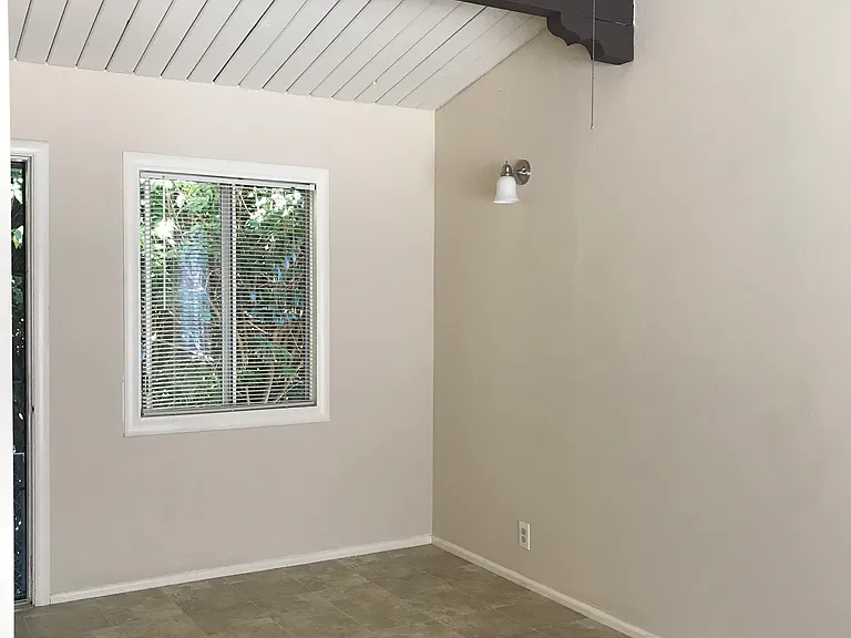 As you move toward the dining area (suitable for a small table and 4 chairs) you have a dining window and the back door. Note ceiling fan and nice high ceilings!