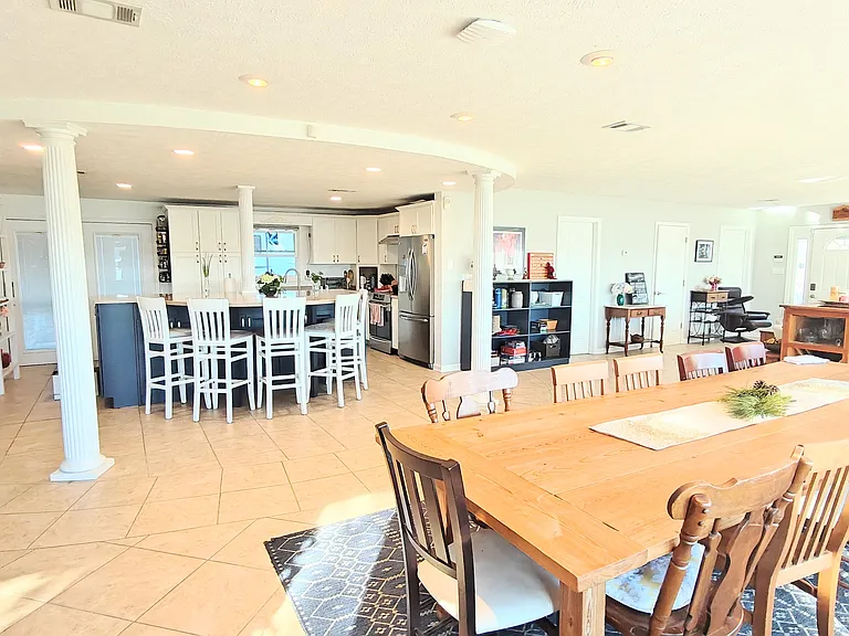 Dining area looking back towards kitchen, laundry room, and front bathroom.