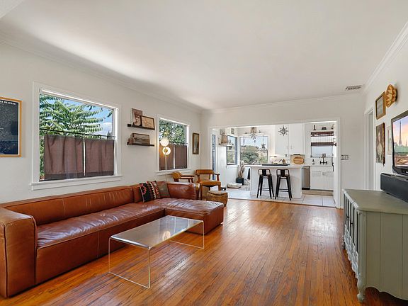 Open floorplan for the Livingroom. Floors were recently redone and a friendly reminder the house come unfurnished.
