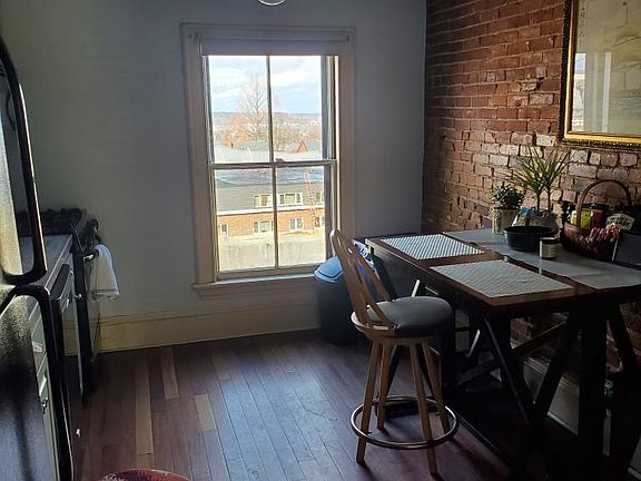 Eat in kitchen with hardwood floor.