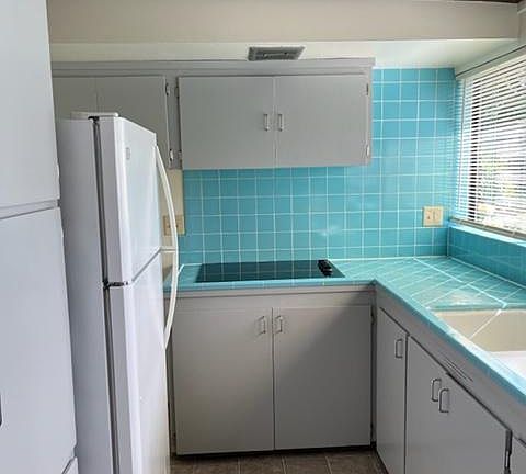 Kitchen with oven and new stove top. Lots of storage. Freshly painted cabinets.