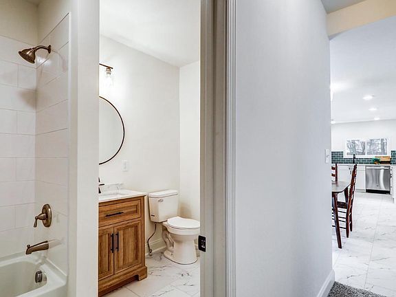 Full bathroom - tub with tiled walls for easy cleaning!