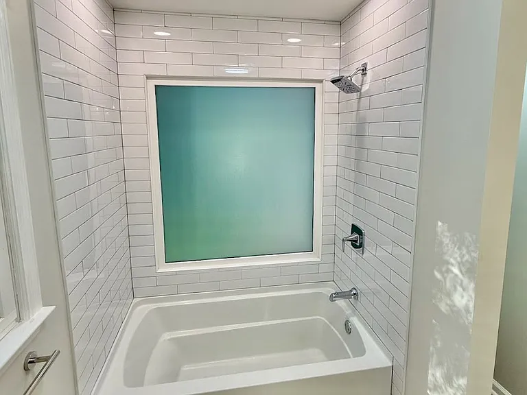 Spa-inspired shower retreat_ floor-to-ceiling tile elevates style and simplifies cleaning in this new shower - unwind in a luxury bath experience that feels like your own home spa.