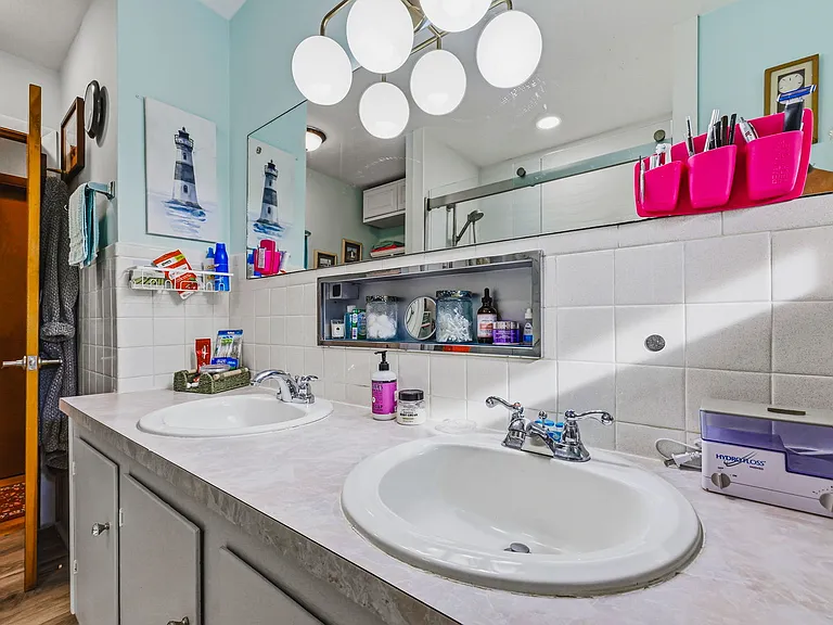MAIN LEVEL Full Bath with Double Sinks (Vanity behind camera, Walk-in Shower to left, and Hall ahead)