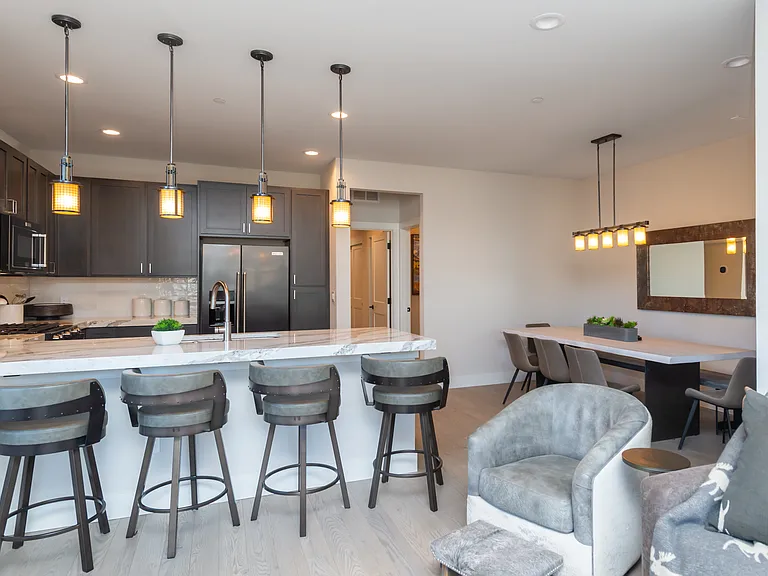 Gourmet kitchen and dining space designed for connection, featuring premium finishes and seating for gatherings of family and friends.